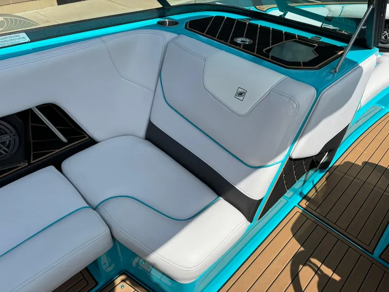 Slide: The Image of 2017 Nautique Super Air Nautique GS22 interior with white and teal seating. - 10