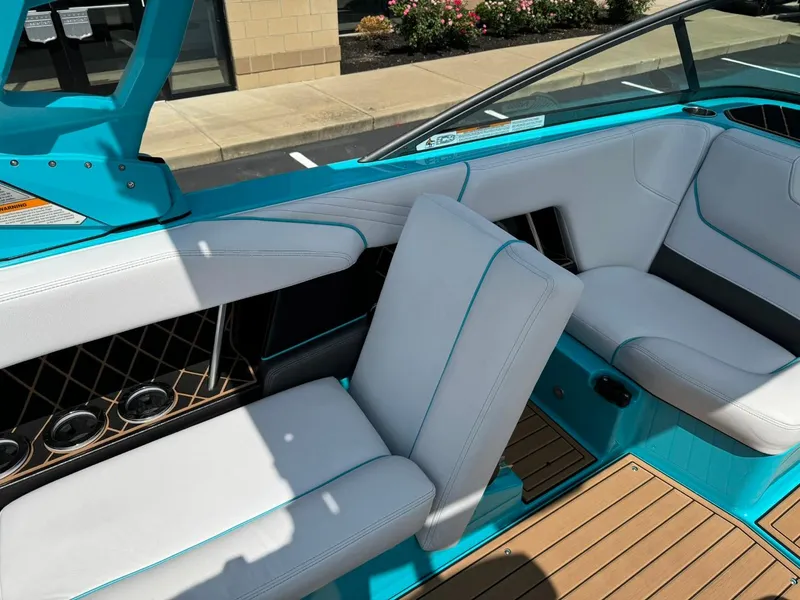 Slide: The Image of 2017 Nautique Super Air Nautique GS22 interior with white seats and teal accents. - 12