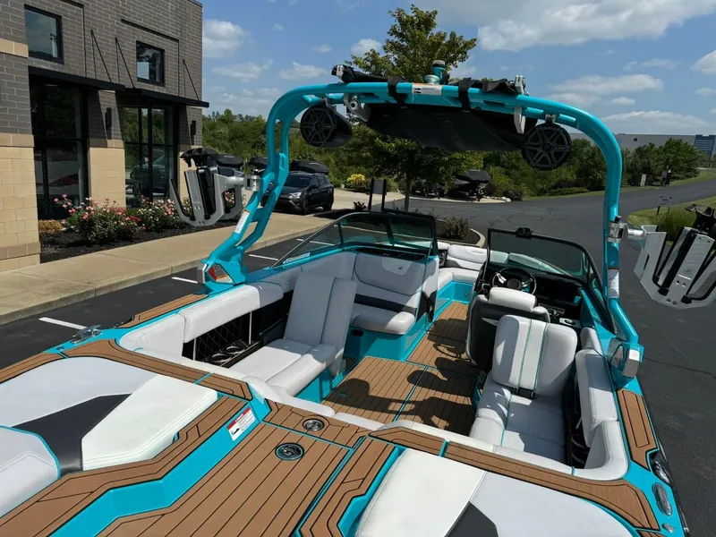 Slide: The Image of 2017 Nautique Super Air Nautique GS22 boat with sleek interior and vibrant blue accents. - 16