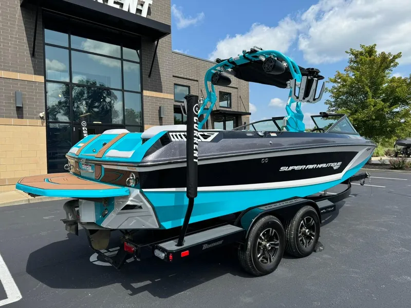 Slide: The Image of 2017 Nautique Super Air Nautique GS22 boat in vibrant blue and black, parked outdoors. - 3