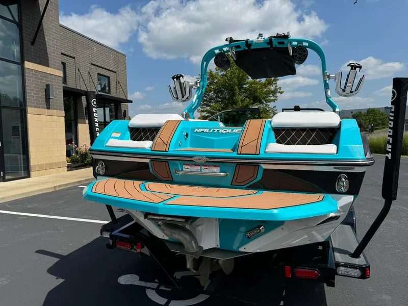 Slide: The Image of 2017 Nautique Super Air Nautique GS22 boat, vibrant blue, parked outdoors. - 4