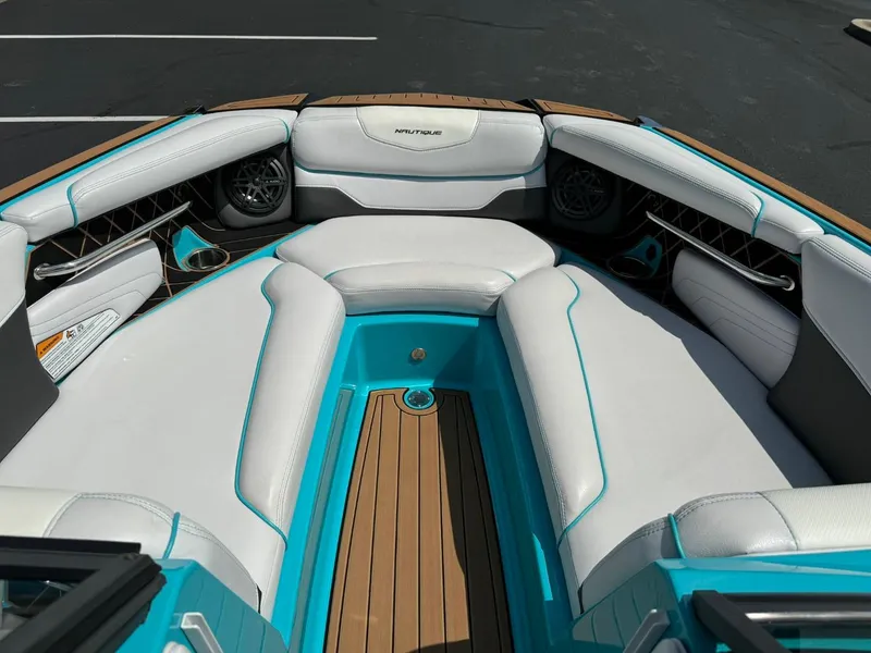 Slide: The Image of 2017 Nautique Super Air Nautique GS22 boat interior with white and teal seating. - 8