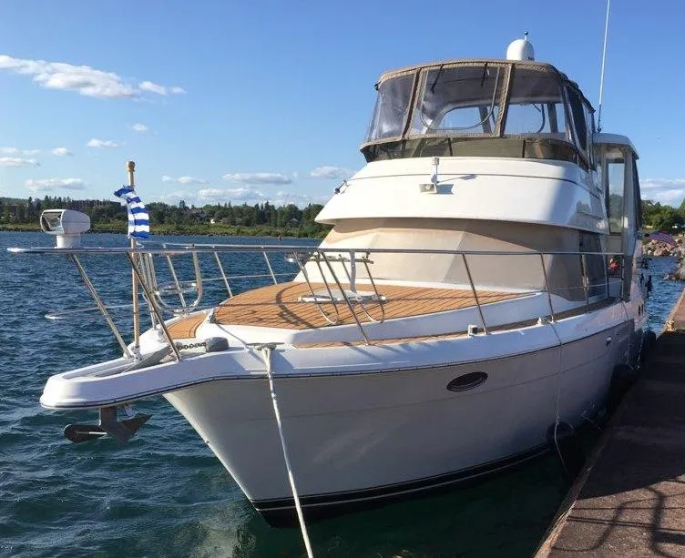 The Image of 2000 Carver 404 Cockpit Motor Yacht docked on a sunny day. - 0