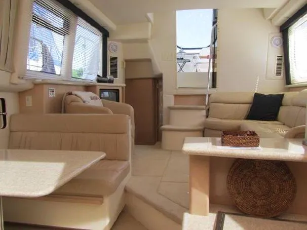 Slide: The Image of Interior of 2000 Carver 404 Cockpit Motor Yacht with beige seating and table. - 14
