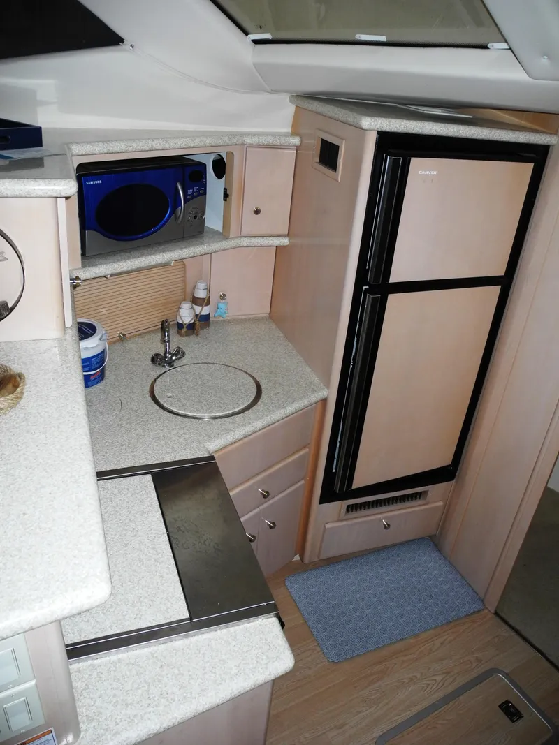 Slide: The Image of 2000 Carver 404 Cockpit Motor Yacht kitchen with fridge, sink, and microwave. - 15