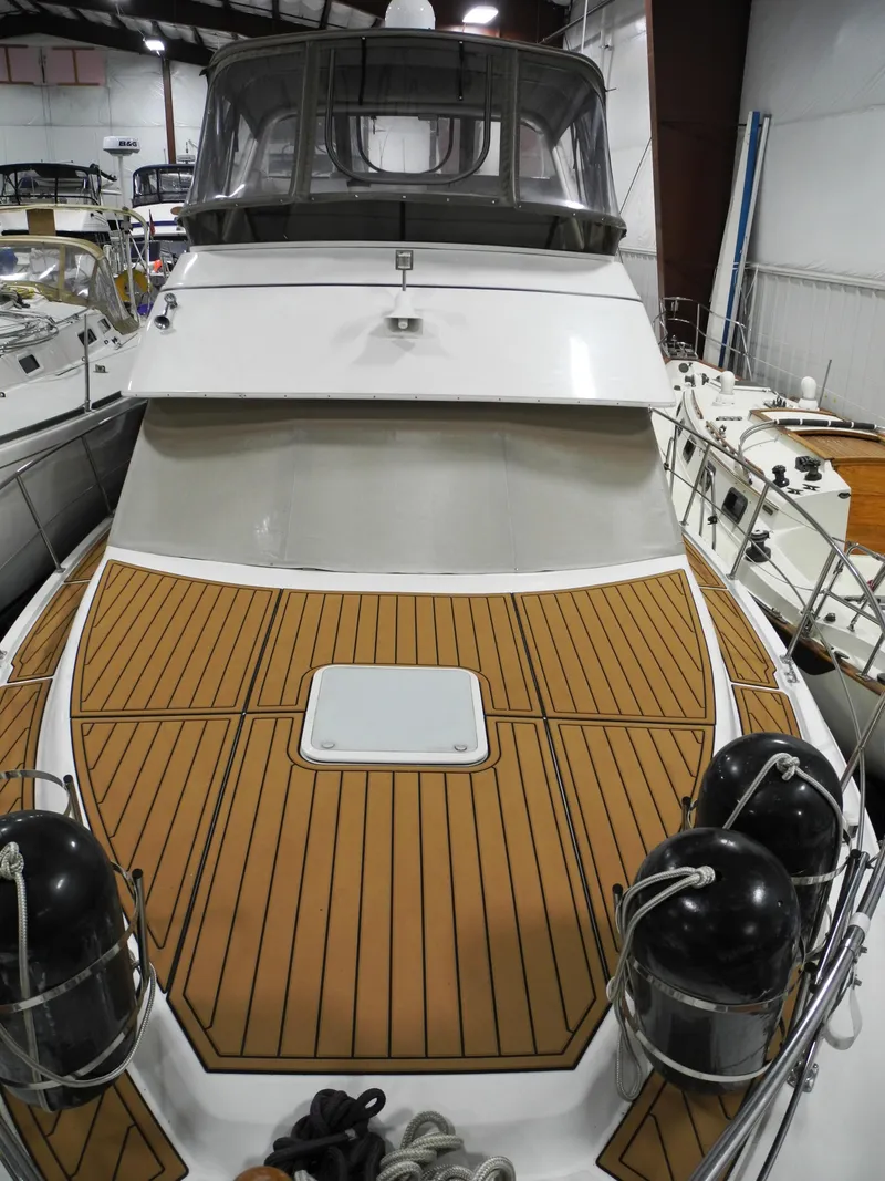 Slide: The Image of 2000 Carver 404 Cockpit Motor Yacht with teak deck in a marina setting. - 3
