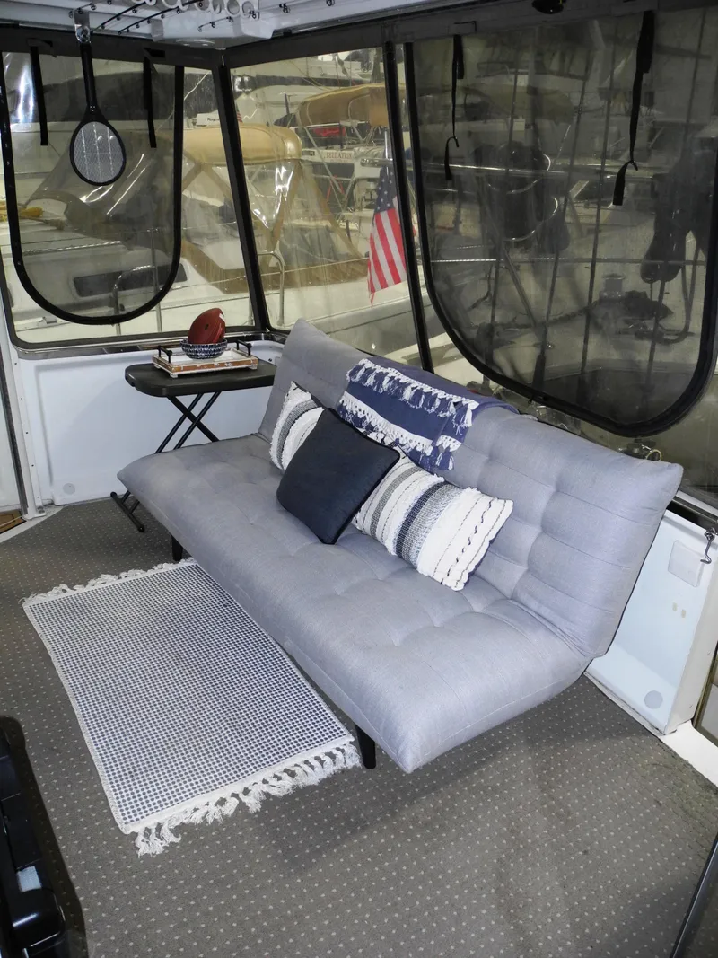 Slide: The Image of Interior of 2000 Carver 404 Cockpit Motor Yacht with gray sofa and nautical decor. - 7