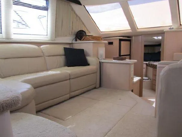 Slide: The Image of Luxurious interior of 2000 Carver 404 Cockpit Motor Yacht with plush seating and natural light. - 11