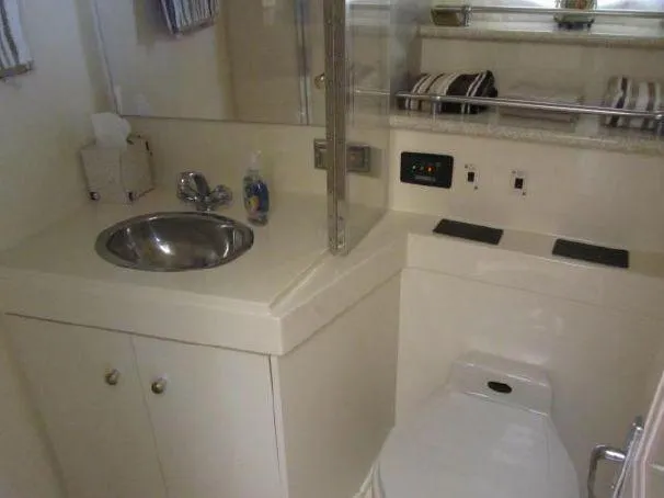 Slide: The Image of Bathroom interior of 2000 Carver 404 Cockpit Motor Yacht with sink and toilet. - 19