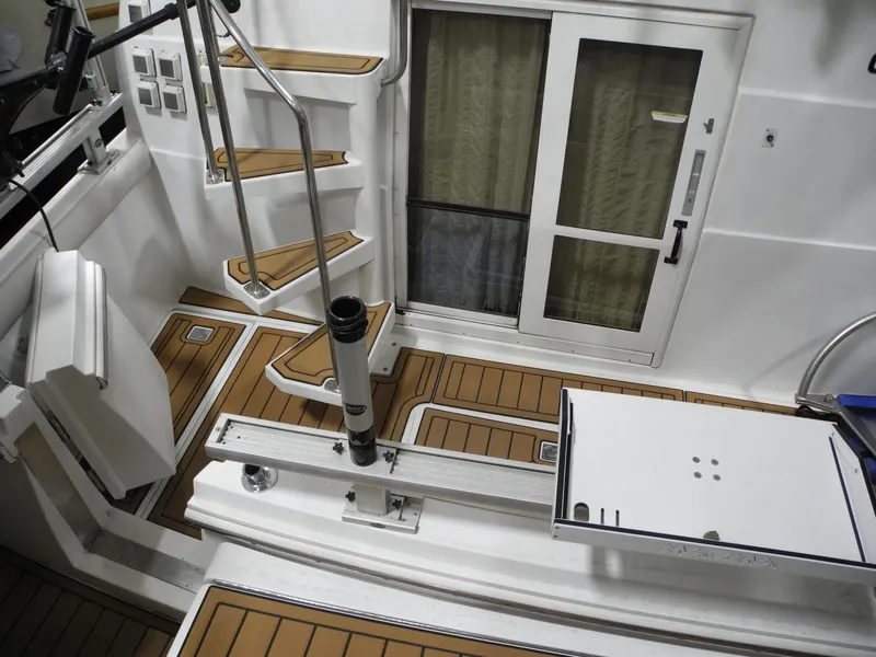 Slide: The Image of 2000 Carver 404 Cockpit Motor Yacht interior with wooden flooring and modern staircase. - 4