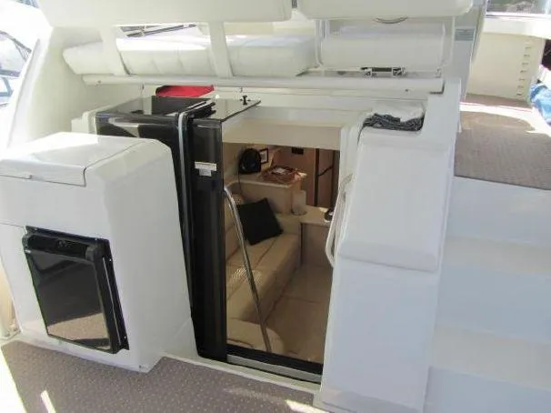 Slide: The Image of 2000 Carver 404 Cockpit Motor Yacht interior with stairs and seating area. - 6