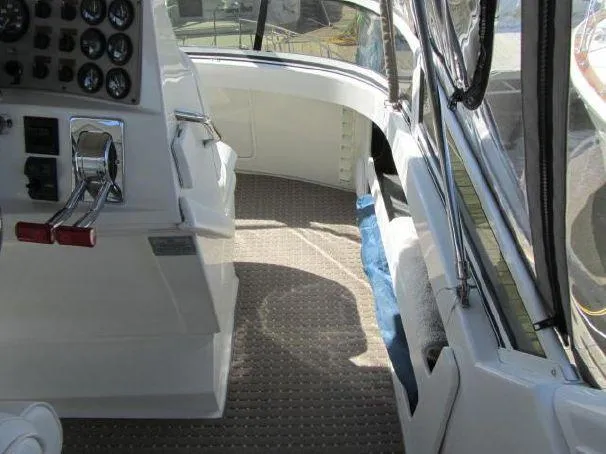 Slide: The Image of 2000 Carver 404 Cockpit Motor Yacht interior with helm controls and seating area. - 8