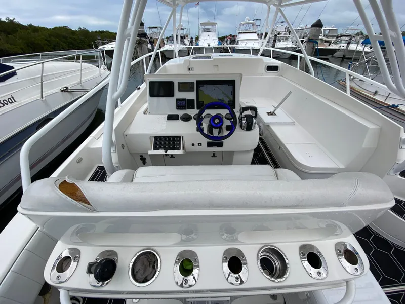 Slide: The Image of 2008 Intrepid 390 Sport Yacht helm with navigation equipment and rod holders. - 14