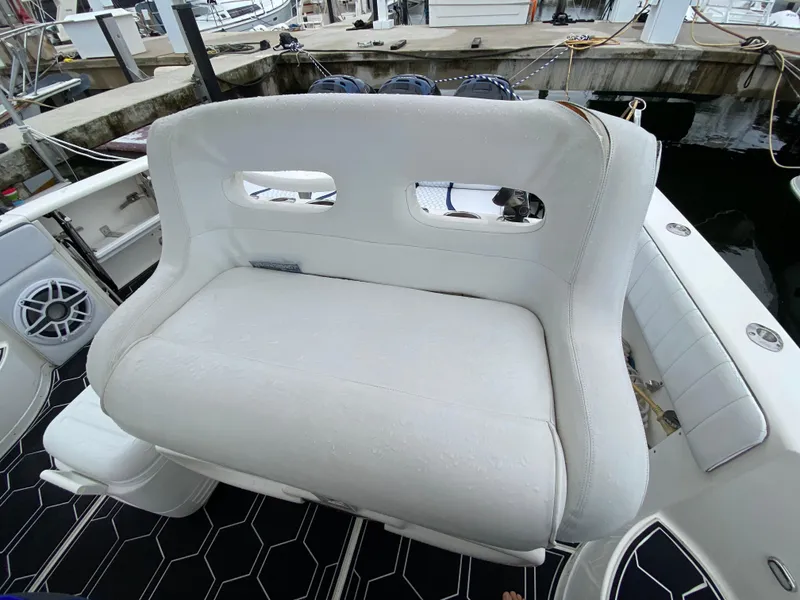 Slide: The Image of 2008 Intrepid 390 Sport Yacht white cushioned seating at the dock. - 16