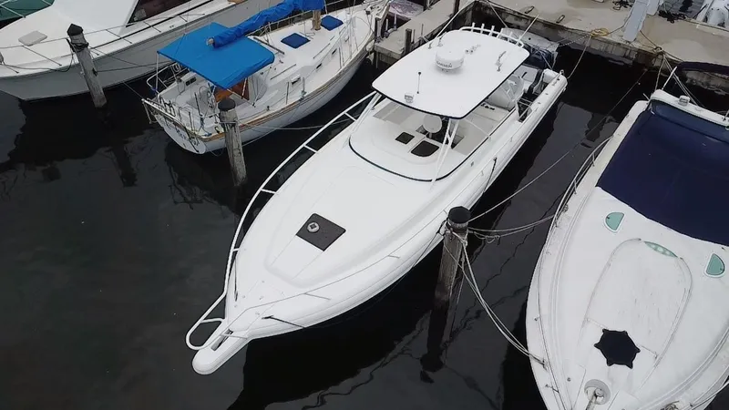 Slide: The Image of 2008 Intrepid 390 Sport Yacht docked among other boats. - 4