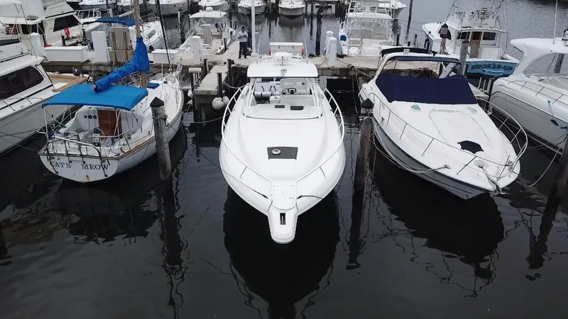 Slide: The Image of 2008 Intrepid 390 Sport Yacht docked between two boats in a marina. - 5