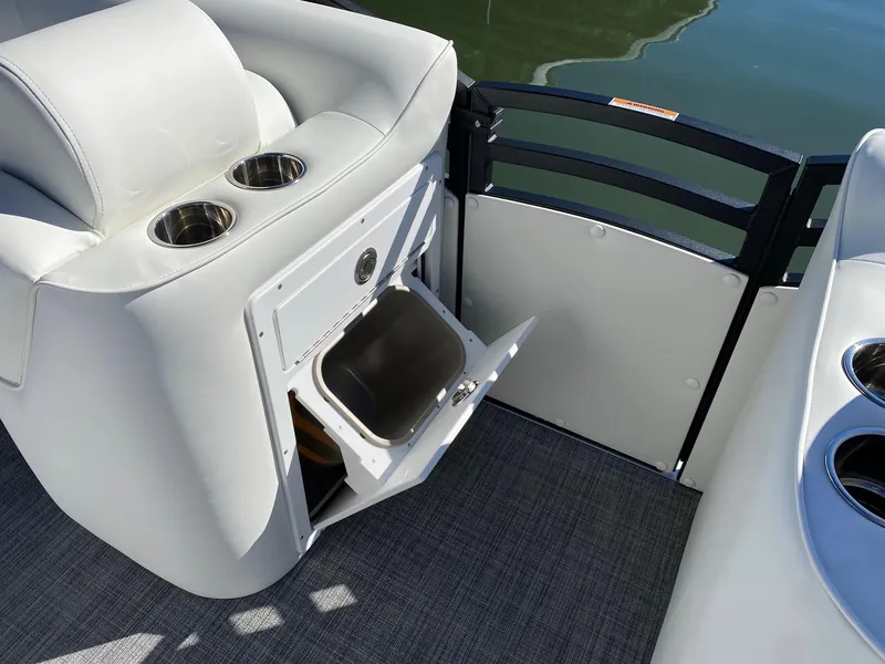 Slide: The Image of 2024 JC Neptoon Sport 23TT boat interior with storage compartment and cup holders. - 11