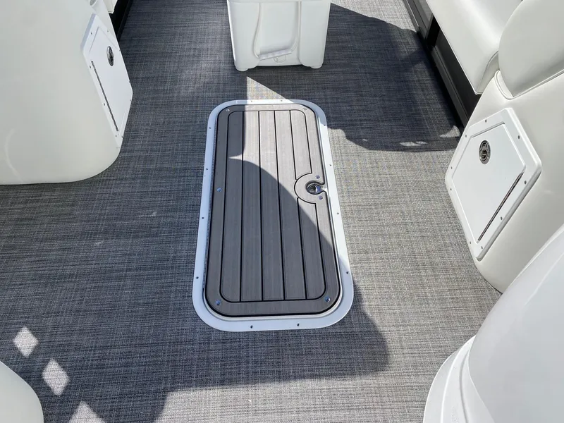 Slide: The Image of 2024 JC Neptoon Sport 23TT boat interior with storage compartment. - 12