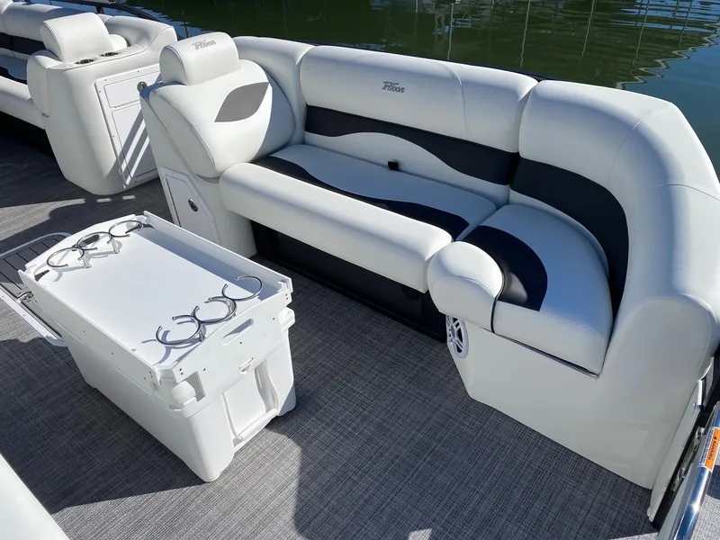 Slide: The Image of 2024 JC Neptoon Sport 23TT pontoon boat interior with plush seating and drink holders. - 5