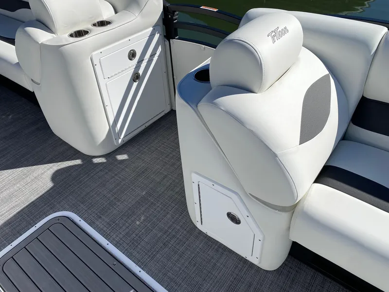 Slide: The Image of 2024 JC Neptoon Sport 23TT boat interior with white cushioned seats and storage compartments. - 7