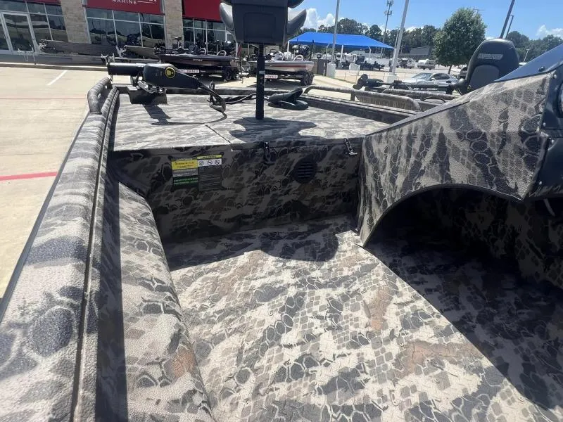 Slide: The Image of 2024 Havoc Boats 1756 FRRSCST with camouflage interior, parked outdoors. - 8