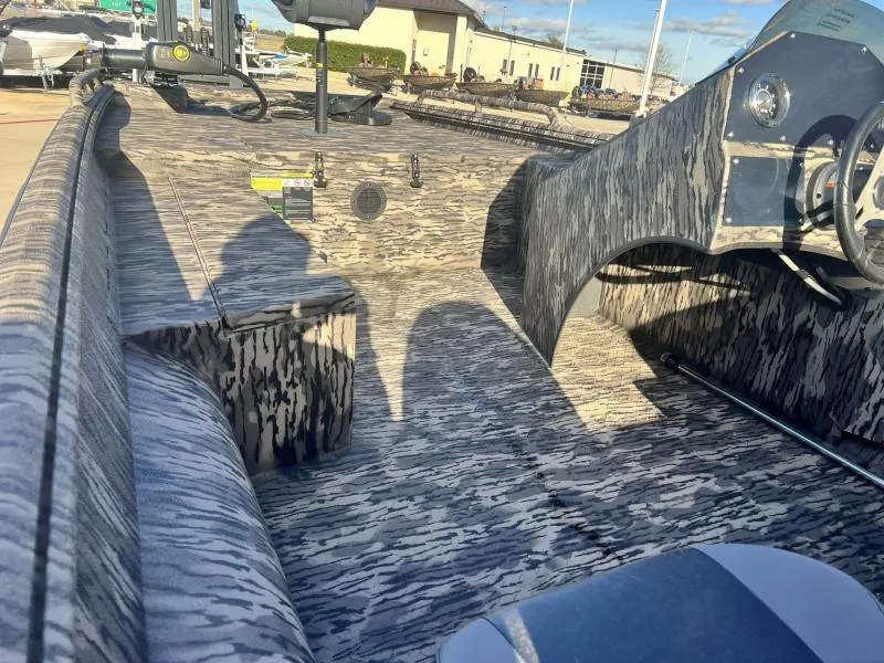 Slide: The Image of 2024 Havoc Boats 1856 FRRSC interior with camouflage pattern and steering console. - 14