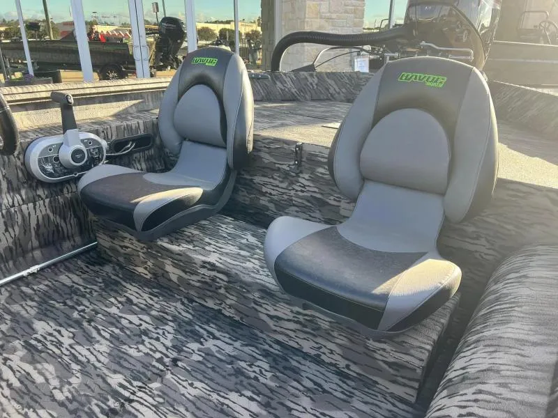 Slide: The Image of 2024 Havoc Boats 1856 FRRSC interior with two grey and black seats. - 15