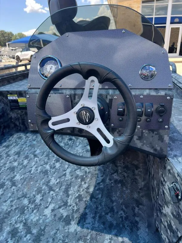 Slide: The Image of 2024 Havoc Boats 1756 FRRSCST steering console with modern controls and camo design. - 8