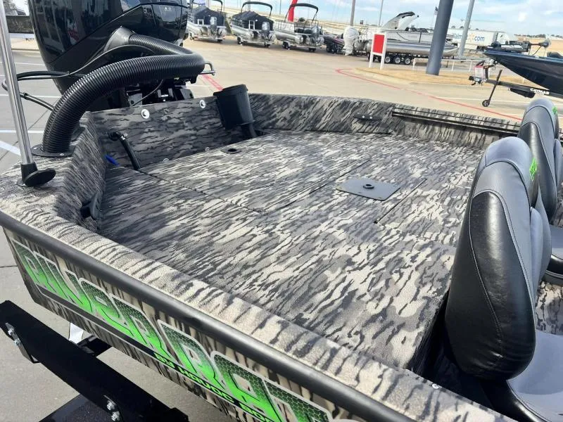 Slide: The Image of 2024 Havoc Boats 1756 FRRSC with camo interior and dual seats, docked at a marina. - 10