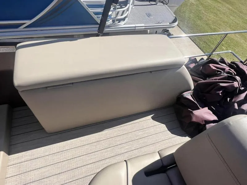 Slide: The Image of 2023 Starcraft SLS-5 Q DH boat interior with beige seating and storage. - 11