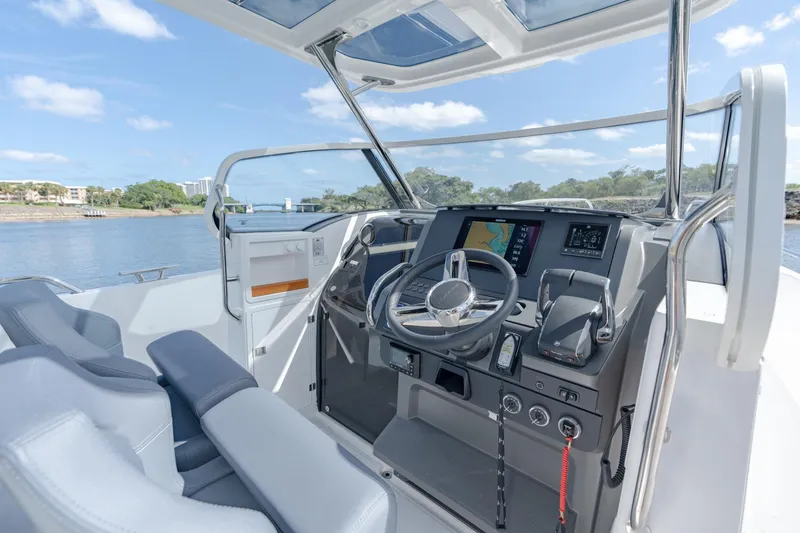Slide: The Image of Interior of 2024 Nimbus Tender 9 #130 boat with modern dashboard and steering wheel. - 5