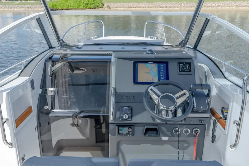 Slide: The Image of 2024 Nimbus Tender 9 #130 boat cockpit with navigation system and steering wheel. - 7