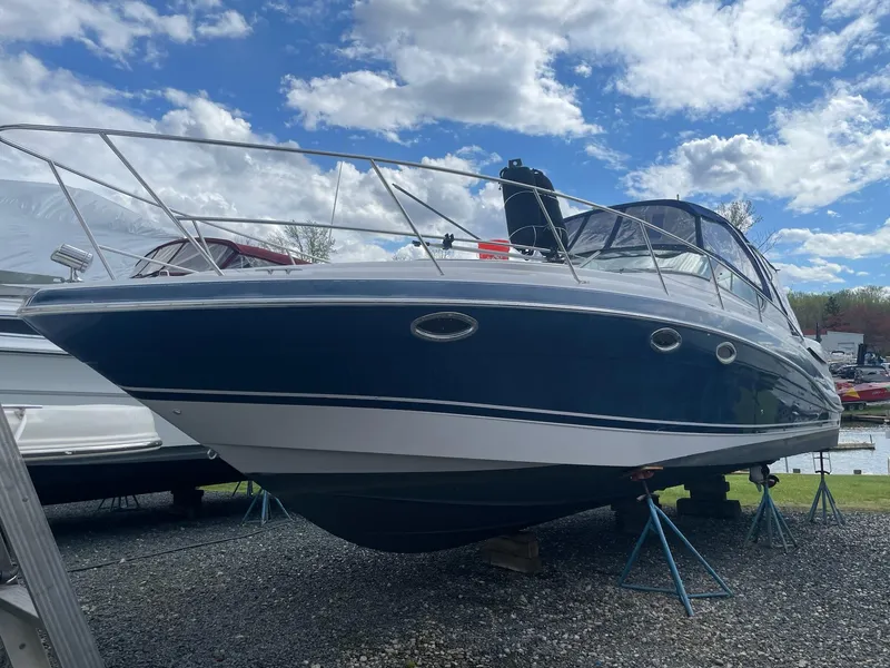 The Image of 2005 Four Winns 348 Vista boat on stands under blue sky. - 1