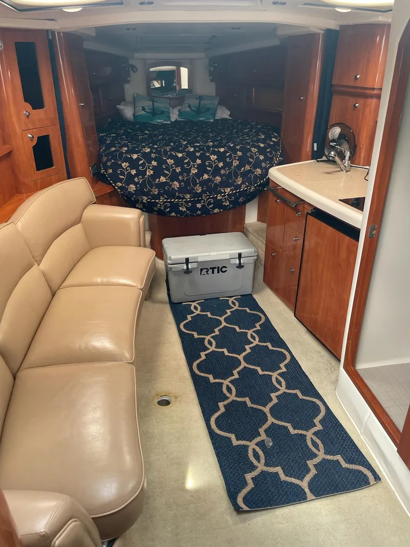 Slide: The Image of Interior of a 2005 Four Winns 348 Vista yacht with sofa and kitchenette. - 11