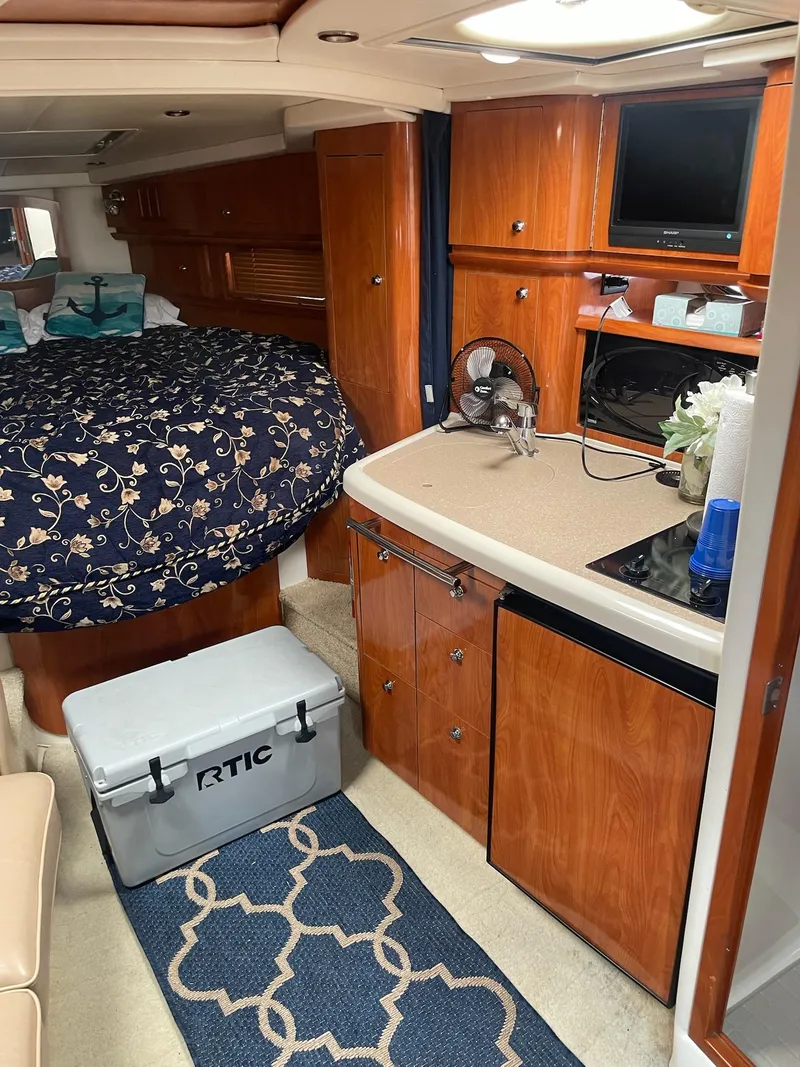 Slide: The Image of Interior of a 2005 Four Winns 348 Vista yacht with kitchen and sleeping area. - 12