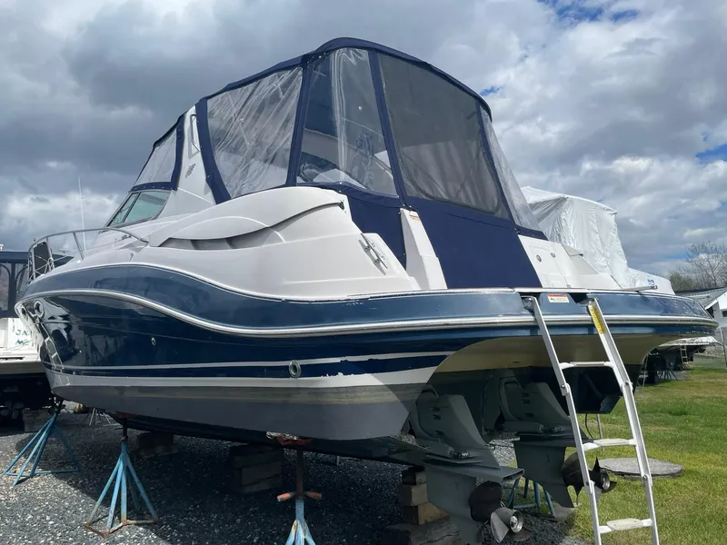 Slide: The Image of 2005 Four Winns 348 Vista boat propped up under cloudy sky. - 4