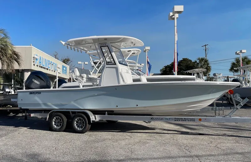 The Image of 2024 Sea Fox 251 Bay Fox boat on a trailer in a dealership lot. - 0