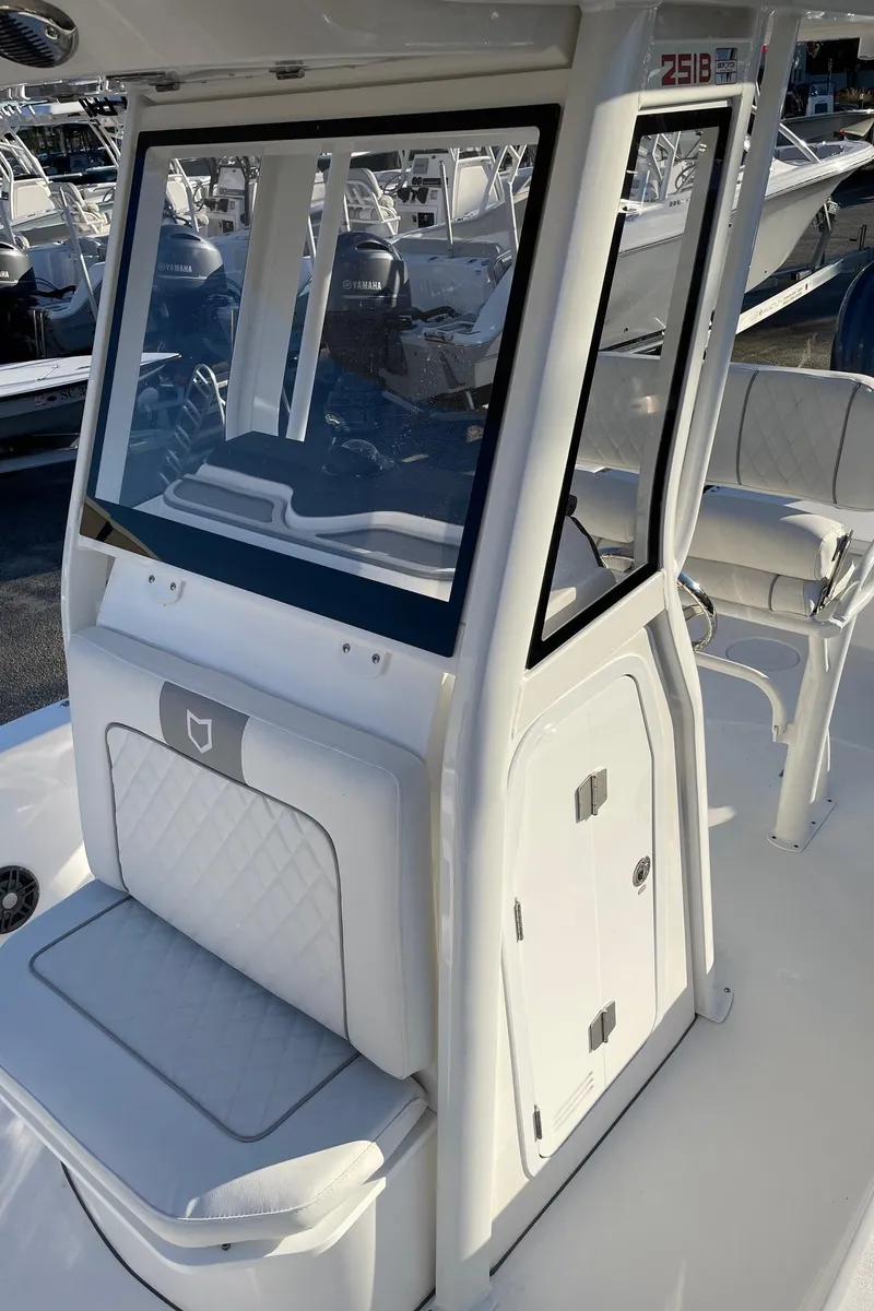 Slide: The Image of 2024 Sea Fox 251 Bay Fox boat with white seating and console. - 11