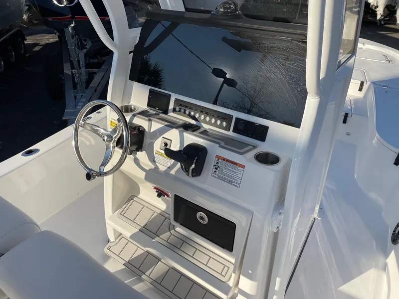 Slide: The Image of 2024 Sea Fox 251 Bay Fox boat console with steering wheel and controls. - 12