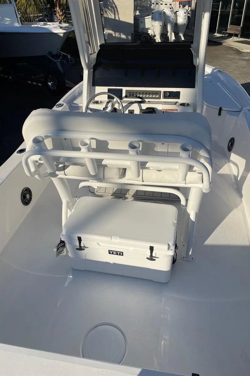 Slide: The Image of 2024 Sea Fox 251 Bay Fox boat interior with seating and cooler. - 14