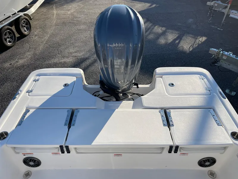 Slide: The Image of 2024 Sea Fox 251 Bay Fox boat with outboard motor and storage compartments. - 19