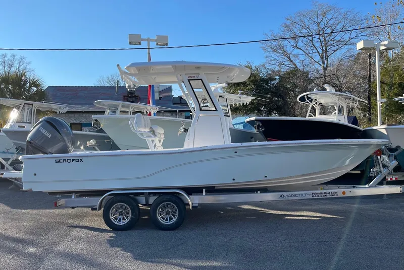 Slide: The Image of 2024 Sea Fox 251 Bay Fox boat on a trailer in a dealership lot. - 2