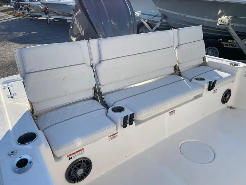 Slide: The Image of 2024 Sea Fox 251 Bay Fox boat with cushioned seating and cup holders. - 20