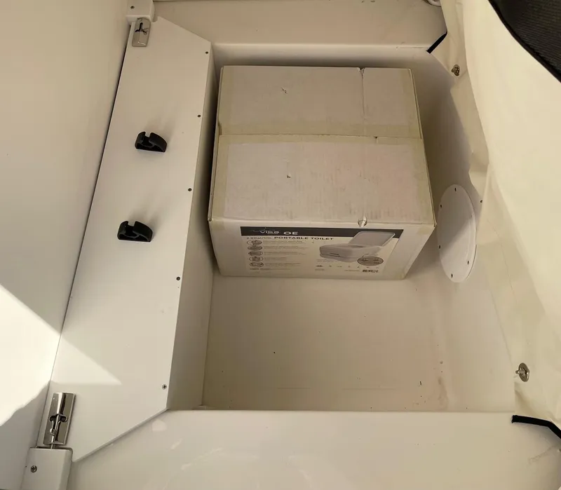 Slide: The Image of Storage compartment of 2024 Sea Fox 251 Bay Fox boat with a boxed item inside. - 27