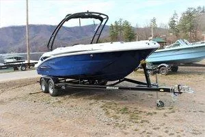Slide: The Image of 2023 Hurricane SUNDECK SPORT 205 I/O boat on a trailer, blue hull, outdoor setting. - 6