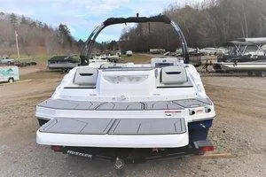 Slide: The Image of 2023 Hurricane SUNDECK SPORT 205 I/O boat rear view in a marina. - 8