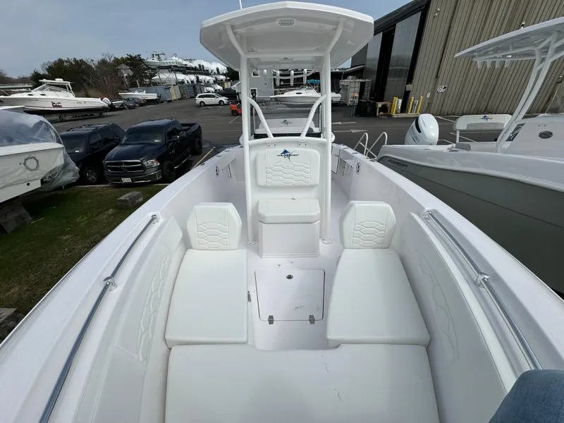 Slide: The Image of 2024 Aquasport 2200 CC center console boat with white seating and storage compartments. - 10