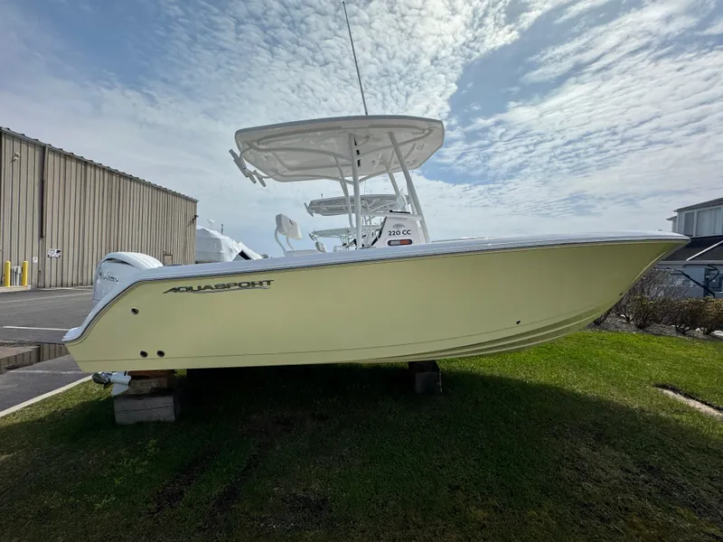 Slide: The Image of 2024 Aquasport 2200 CC boat on display outdoors. - 2