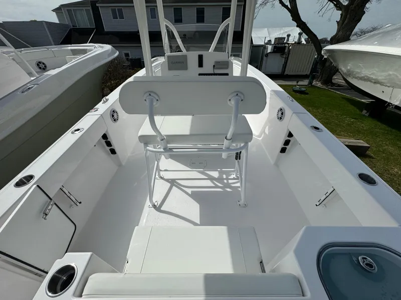 Slide: The Image of 2024 Aquasport 2200 CC center console boat interior with seating and storage. - 4
