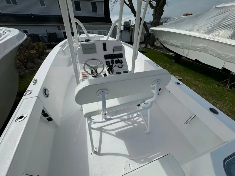 Slide: The Image of 2024 Aquasport 2200 CC center console boat interior with helm and seating. - 5